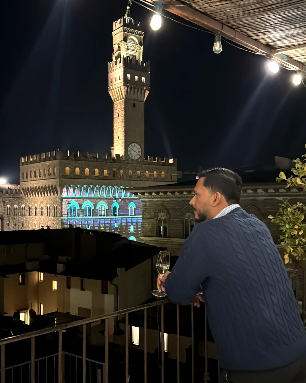 Byron on a rooftop terrace in Europe at night